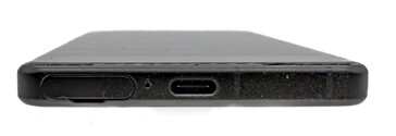 Bottom: SIM card slot, microphone, USB port