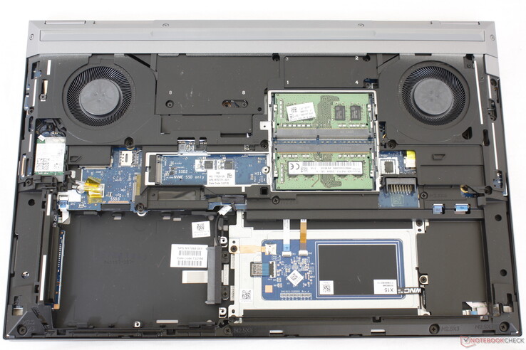 The battery and metal plates have been removed to show two of four SODIMM slots, two M.2 slots, and a 2.5-inch SATA III bay