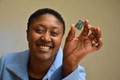 Exec of Intel&#039;s Communication and Devices division, Aicha Evans, holds up a modem. (Source: The Motley Fool)
