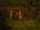 Pictured - a screenshot from the Swordhaven: Iron Conspiracy trailer, showing the protagonist holding a sword in front of a mine entrance. (Image source: Steam)