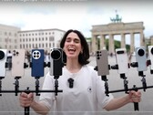 Vivo X200 Ultra crowned king of zoom photography. A person holding the test phones pictured. (Image source: Versus; cropped)