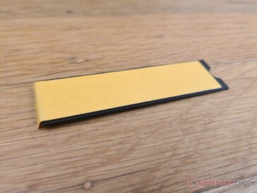 The heat spreader sticks to the SSD with adhesive
