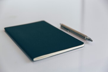 A notebook and a reliable pen are necessities, even in the digital age. (Image via Markus Spiske on Unsplash)