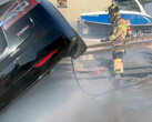 Sacramento firefighter putting out a combusting Model S (image: SFD)
