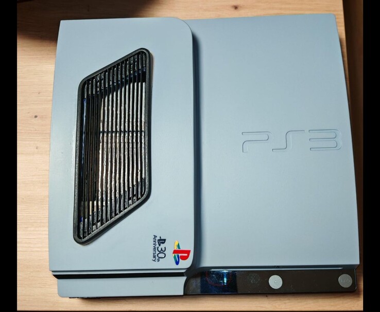 Top view of the custom matte silver-grey PS3 Slim Pro with black accents, featuring a vented grille and a 30th Anniversary PlayStation logo on the case. (Image source: Fun-Equivalent-7785 via Reddit / r/PS3)
