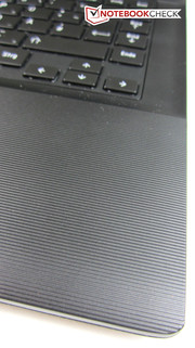 A structured surface surrounds the touchpad.