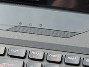 The speakers are located above the keyboard next to the status LEDs.