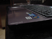 The IdeaPad Y570's twin USB 3.0 ports peek out from under its logo.
