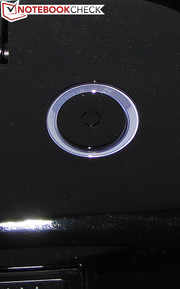 The power button is surrounded by an illuminated ring.