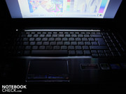 The glossy touchpad buttons are the only reflective elements on the work surface. The glossy touchpad buttons are the only reflective elements on the work surface.