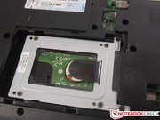 The hard disk is screwed to a frame that is screwed to the case.