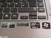 A row of stickers below the keyboard.