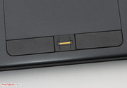 The fingerprint reader is located between the two mouse buttons.