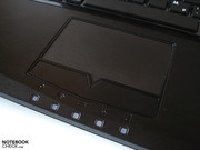 Various status lights are located below the touchpad.
