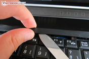 Step I: open the bar above the keyboard with a sharp object (from the inside out)