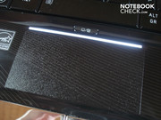 The touchpad is illuminated by a fine bar from above