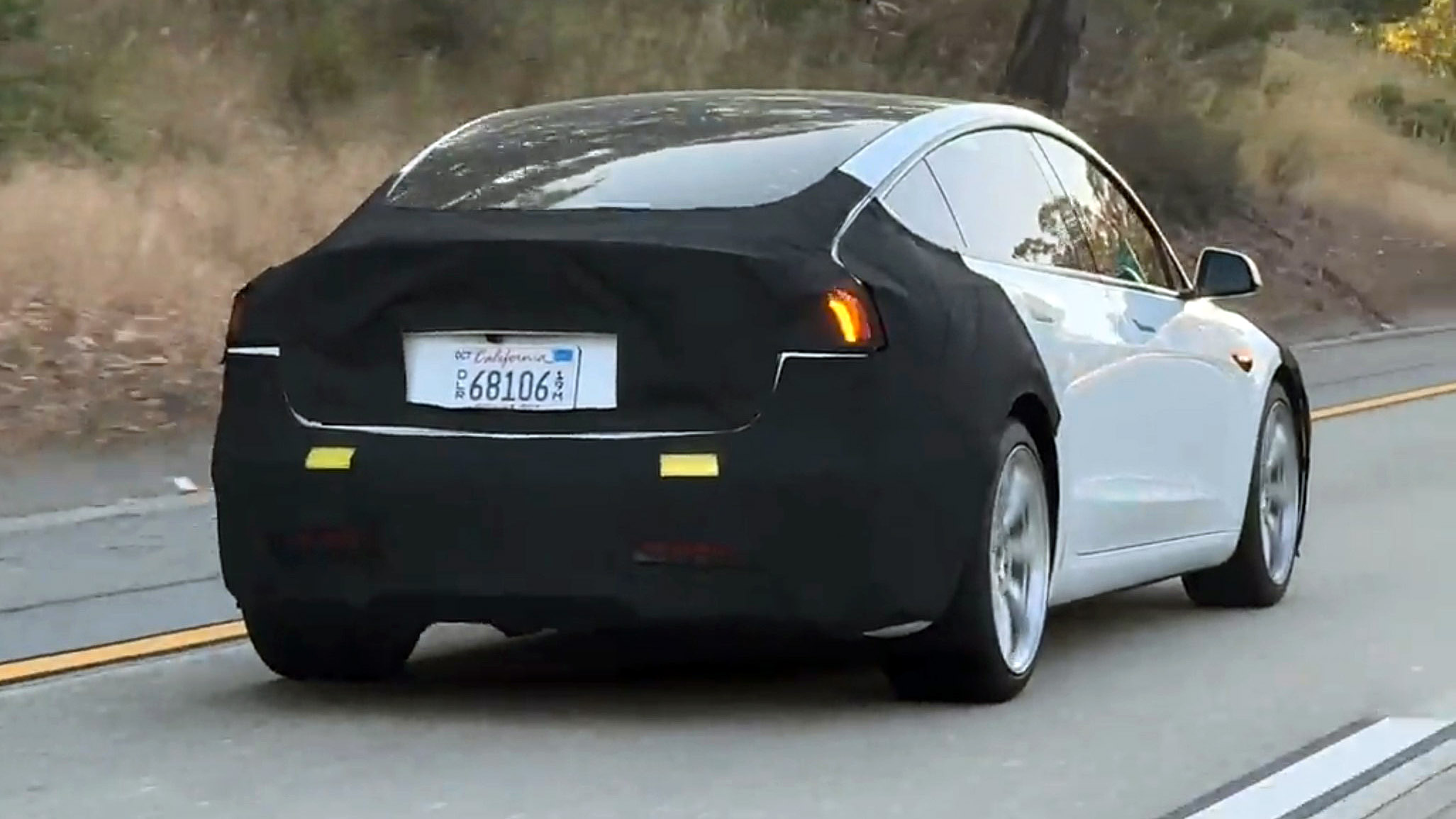Tesla Model 3 Highland taped in motion with separate amber