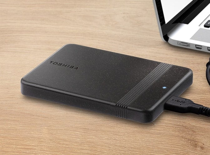 The Toshiba Canvio Ready portable hard drive features a black-colored chassis with rounded corners and a narrow strip for grip.