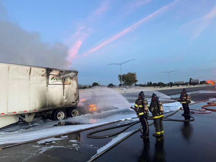 Firefighters trying to extinguish a burning Tesla Semi.