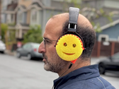 An image of a man wearing scrub daddy headphones.