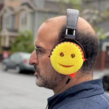 An image of a man wearing scrub daddy headphones.