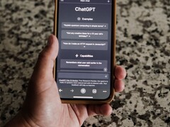 A hand holding a smartphone with the ChatGPT interface open