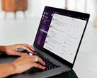 Hands typing on a laptop with a chat application open
