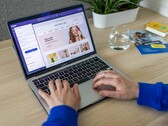 Hands typing on a laptop showing an online shop.
