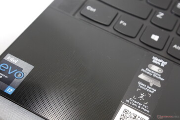 The palm rest and clickpad are glass whereas the keyboard deck is metal. Palm rests are slightly textured with a dot pattern