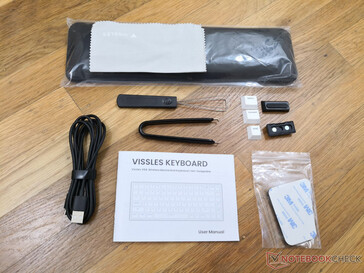 Lots of extras including a palm rest, key cap remover, USB-C to USB-A charging/data cable, swappable Mac keys, sticky pads, and two magnetic feet