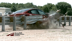 The Model 3 tears through guardrail in a crash test (Image credit: TTI)