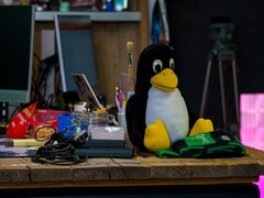 Plush figure of the Linux penguin Tux on a workbench