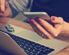 A phone user reading the screen (Image source: Firmbee/Unsplash)