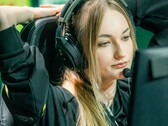 Streamer wearing a gaming headset with a boom microphone in front of a screen during a live broadcast