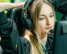 Streamer wearing a gaming headset with a boom microphone in front of a screen during a live broadcast