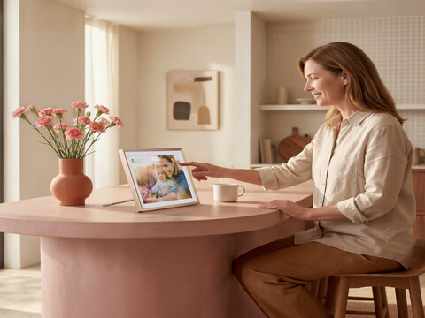 Woman and child playing PS5 game on portable monitor