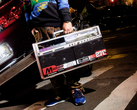A person holding the Bumpboxx BB-777 next to a car.