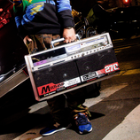 A person holding the Bumpboxx BB-777 next to a car.
