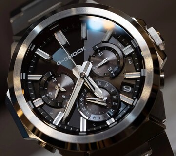 Close-up of the black-dial Casio G-Shock GST-W1000D-1A, showing its three subdials, luminous hour markers, faceted hands, and multi-finish stainless steel bezel.