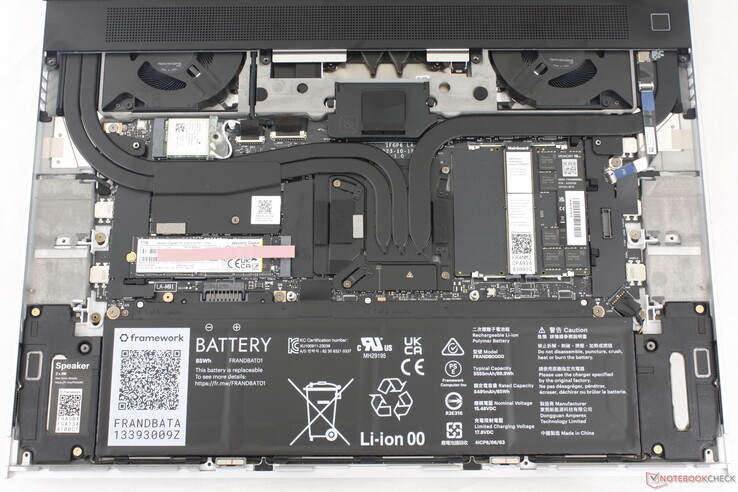 Laptop 16 with keyboard, clickpad, and mid-plate removed. Note the QR codes on most components to aid in replacement parts