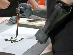 The BrainCo bionic hand in calligraphy action. (Image source: SCMP)