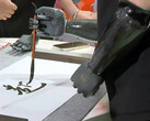 The BrainCo bionic hand in calligraphy action. (Image source: SCMP)
