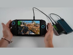 Lenovo Legion Go 2 handheld gaming PC running God of War: Ragnarok, paired with an Adlink Pocket AI GPU enclosure and power bank in a fully portable battery-powered setup. (Image source: ETA Prime via YouTube)