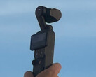 DJI Osmo Pocket compact camera with a blue sky behind it
