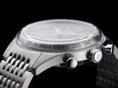 Side profile of the Timex Marlin Jet Chronograph showing its large domed Hesalite crystal, tachymeter scale, brushed stainless-steel case, pump-style chronograph pusher, Jet-branded crown, and stainless-steel bracelet