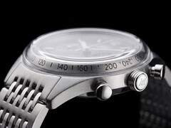Side profile of the Timex Marlin Jet Chronograph showing its large domed Hesalite crystal, tachymeter scale, brushed stainless-steel case, pump-style chronograph pusher, Jet-branded crown, and stainless-steel bracelet