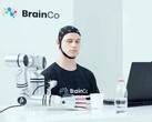 A user of BrainCo's mind-control technology robotically grabbing an apple by thought alone.