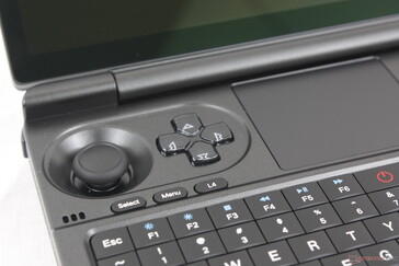 Fingers cover the speaker grilles when handling the controller portion