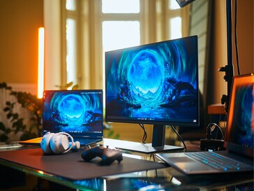 Alienware AW2726DM 27-inch OLED gaming monitor next to laptops