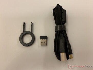 Packaging includes a keycap remover, USB receiver, and USB-A to USB-C cable for charging or wired mode